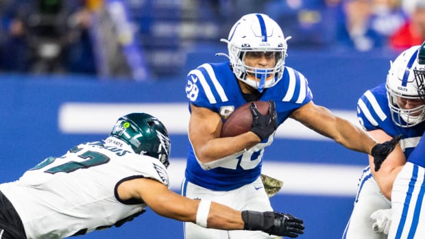 Nov 20, 2022; Indianapolis, Indiana, USA; Indianapolis Colts running back Jonathan Taylor (28) runs the ball while Philadelphia Eagles linebacker T.J. Edwards (57) defends in the second half at Lucas Oil Stadium.